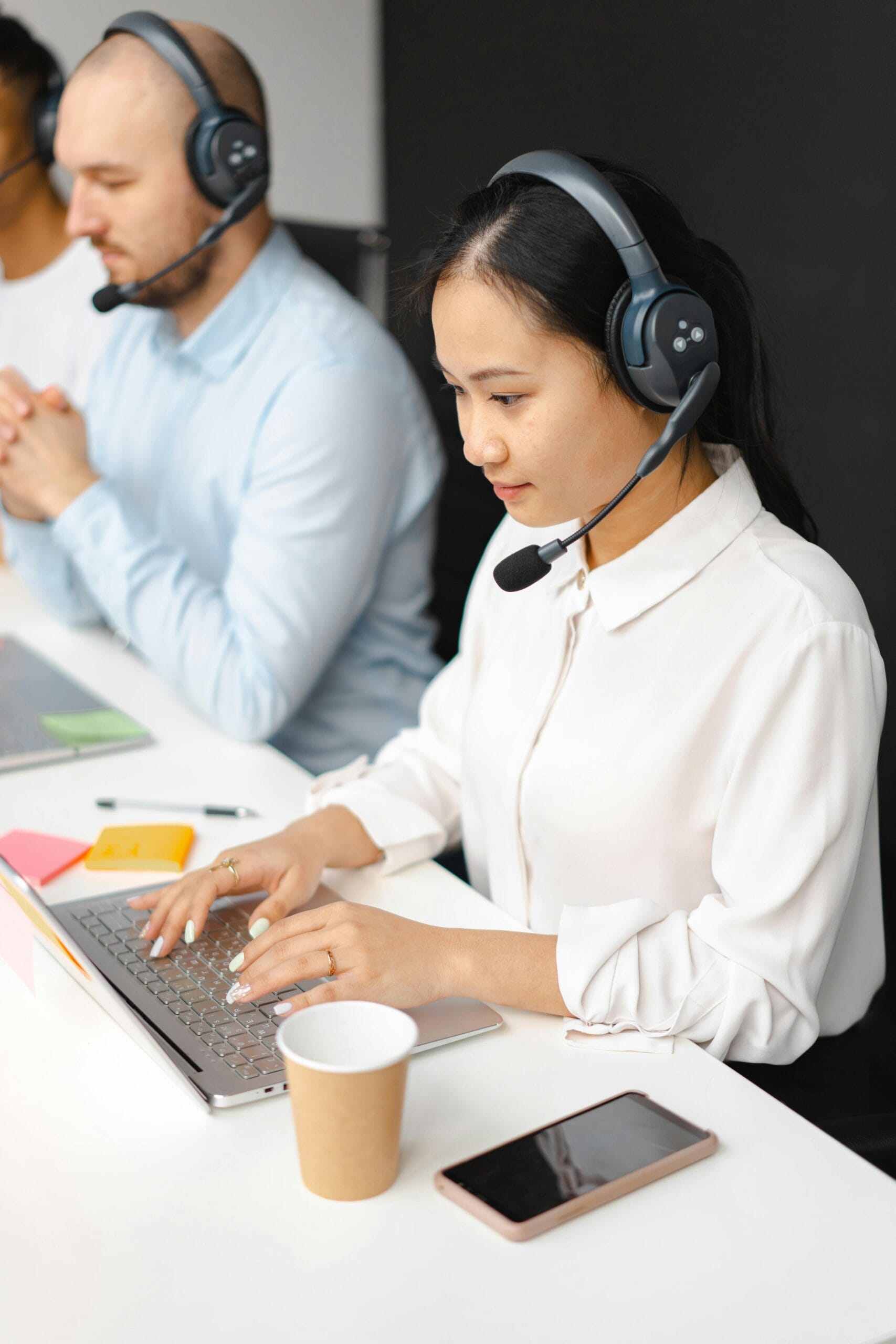 Professionals working in a call center, focusing on customer service and communication.